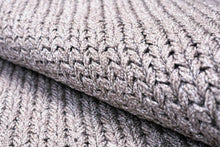 Load image into Gallery viewer, Close-up of a folded chunky knit rug in a heathered light gray color, showing the detailed ribbed texture.