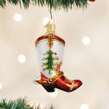 Load image into Gallery viewer, Decorative Christmas ornament shaped like a cowboy boot with a Christmas tree design, hanging on a tree.
