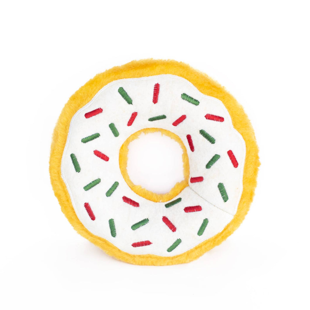Donut-shaped toy with white icing, red and green sprinkles.