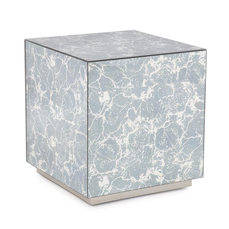 A sleek contemporary cube has been covered in a blueish gray antique mirror to create the Paxton Side Table. With the added touch of a champagne silver base, this table will become a topic of conversation. Also available as a coffee table.