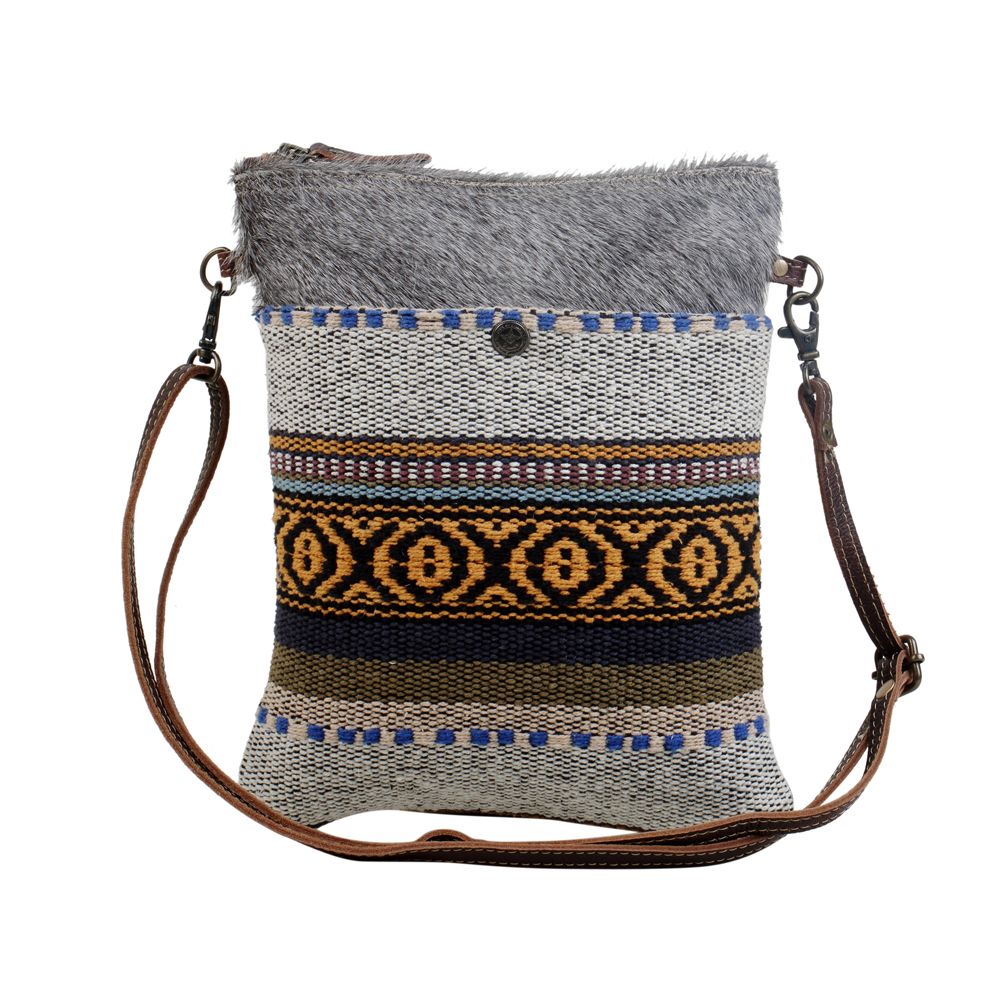 Complete your boho look with this tribal pattern crossbody bag. The compact size of the bag makes it easy to carry and the strong zippered top secures your valuables.