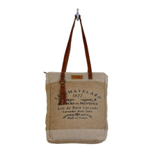 Load image into Gallery viewer, Our all-purpose tote bag is made from responsibly sourced organic jute. It is perfect for travel, grocery shopping, and daily use. A great combination of sustainable fashion and style.
