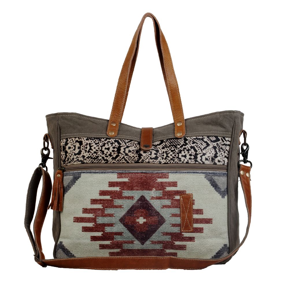 Upcycled from a unique rug, the amber color on the bag stands out against the lighter hues. This spacious messenger bag comes with a strong zippered front and a detachable leather strap. (6537517400262)