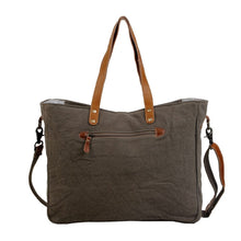 Load image into Gallery viewer, Upcycled from a unique rug, the amber color on the bag stands out against the lighter hues. This spacious messenger bag comes with a strong zippered front and a detachable leather strap. (6537517400262)
